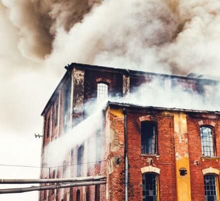 a large brick building with smoke coming out of it
